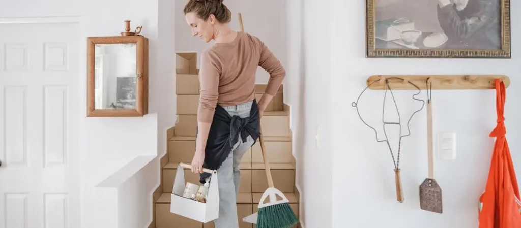 Illustration of a person preparing their home for an appraisal by cleaning and organising.