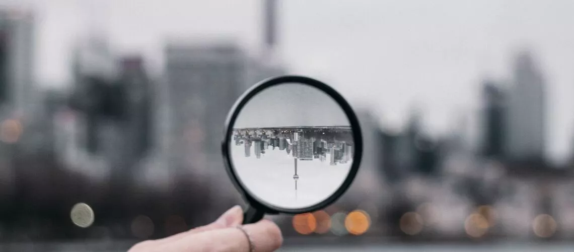 Illustration of a magnifying glass over a house indicating the importance of property valuations in the Australia housing market.